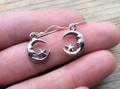 MOON and STAR 925 silver earrings small 1.5cm divine celestial light companionship beautiful sleek gift love friendship Symbolism: The moon is a feminine symbol, universally representing the rhythm of time as it embodies the cycle. The phases of the moon symbolise immortality and eternity, enlightenment or the dark side of Nature herself. According to some Pagan traditions the five pointed star is the four elements of Earth, Fire, Water, and Air with an added human element of spirit. Its five po Champagne Ring, Blue Aura Quartz, Feminine Symbols, Cotton Gift Bag, Five Pointed Star, Gift Love, Moon And Star, 925 Silver Earrings, Aura Quartz