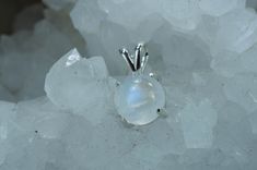 This is a beautiful Rainbow Moonstone from India set in Sterling Silver. This amazing stone has a unique look to them that you will not see with any other stone with its milky color that has flashes of blues, yellows and purples when the light hits them in the right places, just like a Rainbow! This stone has the perfect color and a nice luster due to the rounded cabochon cut. This nicely sized10mm round Rainbow Moonstone weighs 3.900 cts and will go great with most styles or occasions. Check ou White Moonstone Gemstones With Spiritual Style, White Moonstone Gemstones As Gift, White Moonstone Gemstones For Gift, Handmade White Moonstone Gemstones, Spiritual White Moonstone Gemstones, Spiritual White Gemstones For Gift, White Labradorite Round Jewelry, Unique Moonstone Gemstones, White Round Moonstone Gemstones