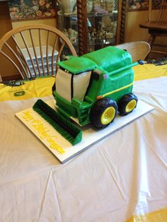 a cake made to look like a tractor on top of a white tablecloth covered table