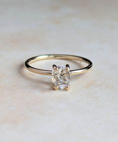 a diamond ring sitting on top of a table