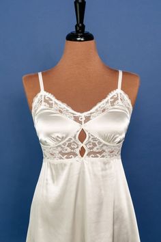 A sweet yet sexy top drawer favorite featuring satin, lace and decorative bows. Feminine Satin Top With Lace Trim, Coquette Lace Trim Camisole For Night Out, Feminine Lace Camisole For Party, Satin Camisole With Lace Trim In Coquette Style, Elegant White Lace Top With Built-in Bra, Lace Coquette Camisole Top, Feminine Lace Top With Lace Trim For Night Out, Feminine Lace Trim Top For Night Out, Lace Camisole Top In Flirty Style