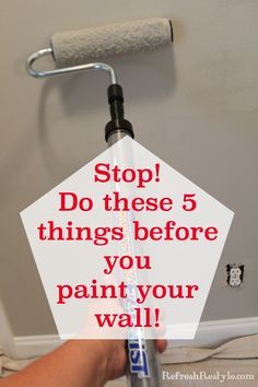 a person holding a paint roller with the words stop do these 5 things before you paint your wall