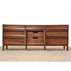 a large wooden sideboard with two drawers on one end and an open drawer on the other