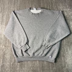 Vintage 2000s Russell Athletic Basic Blank Sportswear Athletic Y2K Aesthetic Grey Pullover Crewneck Extra Large Mens Condition:  Fair Used Condition  = Staining On The Front Of The Sweatshirt Due To Age And Wear  Measurements: Please see photos above for all measurements IF YOU BUY TWO OR MORE ITEMS USE THE CODE BUNDLE @ CHECK TO SAVE 20% WE SHIP WITHIN 24 HOURS AFTER PURCHASE! Please be aware that we do not offer free returns!! The Buyer is responsible for the cost of the return label.  Follow us on TikTok & Instagram @findsnostalgic and tag us in your finds Winter Crew Neck Sweats For Sports Events, Sporty Gray Sweater With Ribbed Cuffs, 90s Crew Neck Sweatshirt For Sports Season, Athletic Heather Tops For Winter Streetwear, Sporty Gray Fleece Sweater, 90s Sweatshirt With Long Sleeves And Ribbed Cuffs, Gray Sportswear Sweatshirt For Streetwear, 90s Style Long Sleeve Sweatshirt With Ribbed Cuffs, Athletic Heather Long Sleeve Sweatshirt For Gym