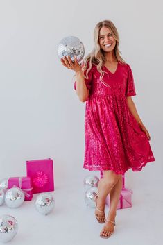 Shine brighter than the Christmas tree in THE ALL THAT SHIMMERS SEQUIN DRESS IN MAGENTA BY PINK DESERT. This shimmering magenta sequin number boasts pink sequins, short puff sleeves, and a flattering V-neck. It's exclusive to Pink Desert and guaranteed to make your holidays more sparkly (in the best possible way). Mage Sparkly Holiday Dress, Happy Threads, Summer Goddess, Pink Desert, Exclusive Clothing, Mom Dress, Pink Sequin, Senior Year, Eras Tour