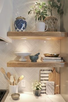 the shelves in the kitchen are filled with dishes and cooking utensils on them