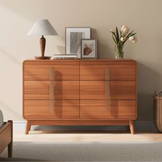 a wooden dresser sitting in a living room next to a lamp