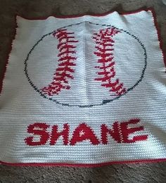 a crocheted afghan with a baseball and the word shane written on it