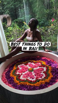 a woman sitting in front of a large flower pot with the words best things to do in bali