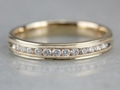 a yellow gold wedding band with white diamonds