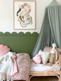 a child's bedroom with a canopy bed and pillows on the bottom half of the bed