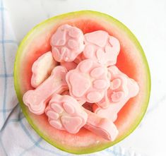 a watermelon filled with marshmallows on top of a blue and white towel