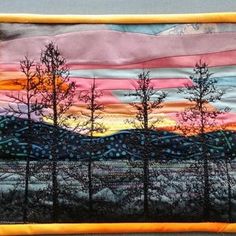 a painting on a wall with trees and mountains in the background at sunset or sunrise