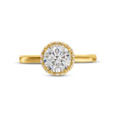 a yellow gold engagement ring with an oval cut diamond