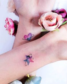 two small tattoos on the wrist and foot with flowers around them, one has a butterfly