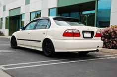 a white car parked in front of a building