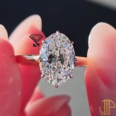 a close up of a person holding a diamond ring