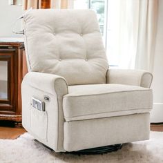 a white recliner chair sitting in front of a window