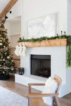 a living room with a christmas tree and fireplace