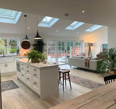 an open concept kitchen and living room with skylights