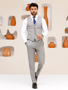 This grey 3-piece slim-fit suit is the epitome of sophistication and style. The jacket features wide lapels, creating a bold statement and showcasing a keen eye for detail. The vest, with its matching lapels, further elevates the aesthetic and provides a cohesive look. Upgrade your wardrobe with this standout piece and make a lasting impression at your next event. Color: grey Material: 60% wool, 30% polyester, 7 viscose, 3% elastane Suit includes blazer, waistcoat, & trousers Single-breasted sui Slim Fit Three-piece Suit With Single Button, Semi-formal Slim Fit Three-piece Suit With Lapel Collar, Semi-formal Slim Fit Three-piece Suit With Single Button, Semi-formal Slim Fit Three-piece Suit, Gray Fitted Three-piece Suit, Elegant Gray Fitted Three-piece Suit, Elegant Fitted Gray Three-piece Suit, Slim Fit Three-piece Suit For Business Casual, Slim Fit Three-piece Suit With Suiting Fabric