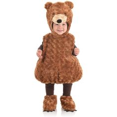 a little boy dressed in a bear costume