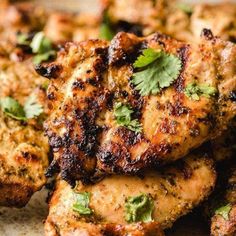 grilled chicken with cilantro and parsley on the side, ready to be eaten