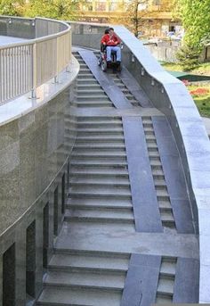 a man riding a scooter down some stairs