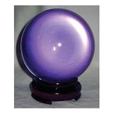 a purple ball sitting on top of a wooden stand