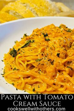 pasta with tomato cream sauce on a white plate