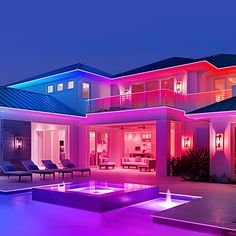 a large house that is lit up with colorful lights in front of the pool area