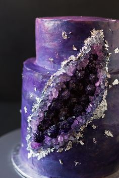 a purple cake with silver sprinkles on it