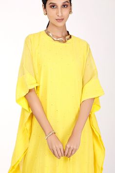 Yellow chanderi kaftan with badla and mukaish embroidery. Comes with a butter crepe inner.
Component: 2
Pattern: Embroidered
Type Of Work: Badla, Mukaish
Neckline: Round
Sleeve Type: Three quarter
Fabric: Kaftan : Chanderi, Inner : Butter crepe
Color: Yellow
Other Details: 
Back button
Note : Necklace worn, potli held by the model is not for sale.
Occasion: Puja - Aza Fashions Mukaish Embroidery, Yellow Kaftan, Embroidered Kaftan, Not For Sale, Aza Fashion, Sleeve Type, Three Quarter, Types Of Sleeves, Butter