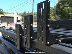 the back end of a black truck with metal brackets on it