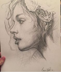 a pencil drawing of a woman's face with flowers on her head and hair