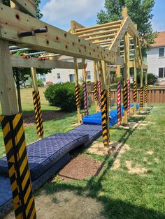 a row of wooden benches sitting on top of a lush green field