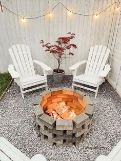 an outdoor fire pit with chairs around it