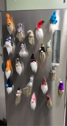 a refrigerator covered in assorted gnome hats