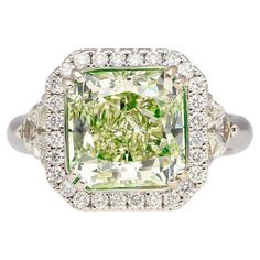 Jewelry Details: Item Type: Diamond Ring Metal Type: 18K White Gold Weight: 7.27 grams Ring Size: 6 Center Stone Details: Gemstone Type: Diamond Shape: Radiant Cut Carat: 4.26 Carats Color: Fancy Yellowish Green Clarity: SI1 Certification: GIA Certified Certificate Number: #2145802932 Side Stone Details: Gemstone Type: Diamonds Carat:Half-Moon Diamonds: 0.50 Carats Round Cut Diamonds: 0.50 Carats Description: This 18K White Gold Diamond Ring features a GIA Certified 4.26 Carat Radiant Cut Fancy Exquisite Luxury Green Diamond Ring, Fancy Color Diamond Ring, Colored Diamond Jewelry, Yellowish Green, Expensive Jewelry Luxury, Gold Diamond Ring, White Gold Diamond Rings, Expensive Jewelry, Green Diamond