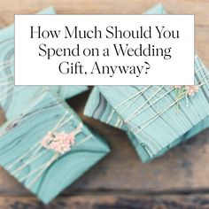 four blue gift boxes with the words how much should you spend on a wedding gift?