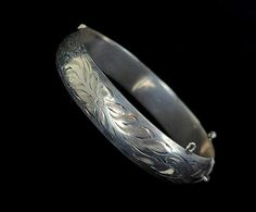 "Vintage Mid-Century Sterling Burkhardt Birks Canada Engraved Floral Thick Bangle Bracelet 7\" Item offered is an antique sterling engraved etched Burkhardt floral bangle bracelet. This bracelet consists of gorgeous etched floral designs. The clasp is a tab insert clasp. There is no safety chain attached. Condition is good, with age related wear. Inside is marked \"Sterling\" and \"B\". Please see photos provided as they are an extension of our written description. Measurements: Bracelet length: Engraved Bracelets For Weddings And Festivals, Engraved Bracelets For Wedding And Festivals, Engraved Cuff Bracelet For Wedding And Festivals, Engraved Bangle Bracelet For Wedding, Festive Engraved Bangle Bracelet, Wedding Etched Round Bangle, Formal Etched Bangle, Etched Bangle Bracelets For Wedding, Etched Bangle For Wedding