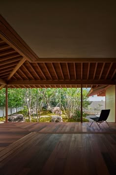 an empty room with wooden flooring and large sliding glass doors leading to the outside