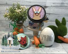 an easter decoration with bunny ears and carrots