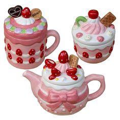 three ceramic teapots with designs on them and one has an ice cream sundae