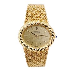 Ladies Corum 26mm x 30mm Oval Vintage 18K Yellow Gold Watch with Gold Dial and Weave Bezel. Pre-Owned SN# 163**** Brand: Corum. Dial Color: Gold. Type: Wristwatch. Gender: Women's. Condition: Excellent. Bezel: 18K Yellow Gold. Total Weight: 62 Grams. Case Size: 26mm x 30mm. Movement: Quartz (Battery). Band Material: 18K Yellow Gold. Bezel Material: 18K Yellow Gold. Bracelet Size: Fits 6.5" to 6.75" Wrist. Warranty: One (1) Year Limited Service Warranty. Luxury Gold Oval Watch, Luxury Oval Gold Watches, Yellow Gold Oval Watch For Gift, Oval Yellow Gold Watch As Gift, Oval Yellow Gold Watches For Gifts, Gold Oval Watch With Diamond Hour Markers, Gold Oval Watches With Diamond Hour Markers, Gold Oval Watches For Anniversary, Timeless Oval Diamond Watch For Formal Occasions