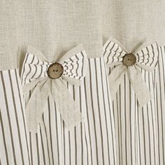 the curtain is decorated with buttons and bows