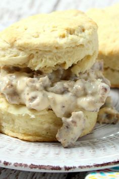 buttermik biscuits in sausage gravy on a plate with text overlay