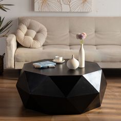 a living room with a couch, coffee table and two vases on the floor