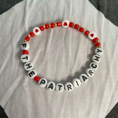 a red and white beaded bracelet with the words, i love the patria on it