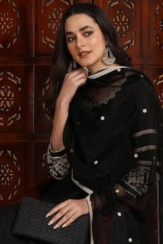 Black Silk Blend Solid Embroidered Anarkali Suit Set Expertly crafted with a luxurious silk blend and intricate embroidery, this Anarkali suit set is the epitome of elegance and opulence. It's the perfect addition to your wardrobe for any special occasion, offering a timeless and sophisticated look that is sure to turn heads. Style NoteComplete the LookThis suit set is versatile enough to be dressed up or down. For a daytime event, pair it with sandals and a statement scarf. For a night out, add Black Chanderi Churidar With Embroidered Border, Chanderi Churidar With Embroidered Border In Black, Elegant Dola Silk Anarkali Set With Embroidered Border, Elegant Sharara For Navratri With Embroidered Border, Elegant Churidar With Chikankari Embroidery In Art Silk, Festive Elegant Anarkali Set With Embroidered Border, Black Chanderi Kurta With Embroidered Border, Elegant Art Silk Churidar With Embroidered Border, Black Churidar With Chikankari Embroidery For Designer Wear